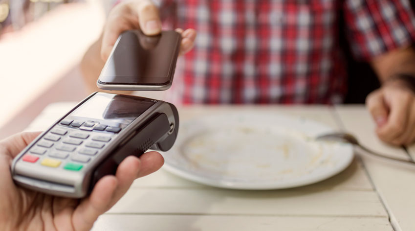 Making a contactless payment with a mobile phone.